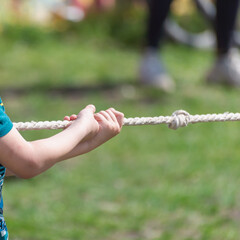 The child pulls the rope.
