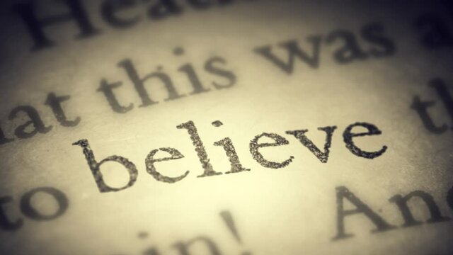 The word believe on an old page in the book is separated from the general text and zooms into the camera. Creative 3D 4k slow motion video animation.