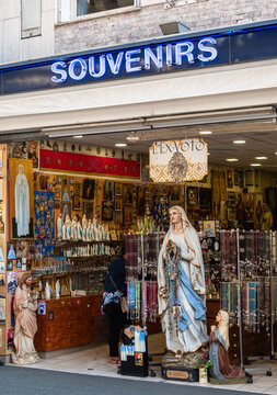 Lourdes, France - August 28, 2021: A Souvenirs Shop In Lourdes, Selling Devotional Objects To Pilgrims.