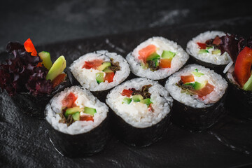 sushi on a black plate