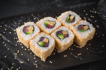 sushi on a black plate