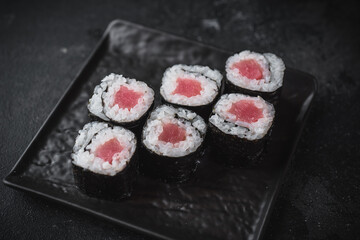 maki sushi on a black plate