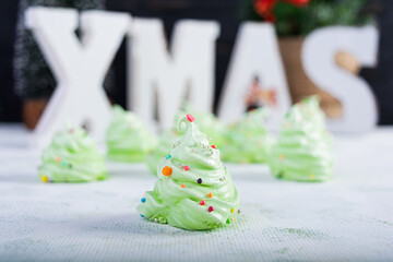 Meringue cookies with Christmas decoration. French dessert. Christmas tree of meringue