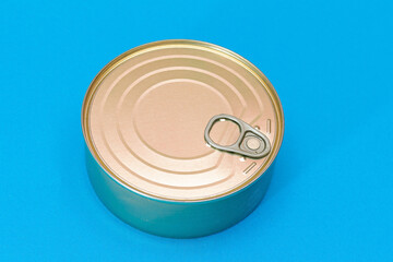 Unopened Tin Can with Blank Edge on Light Blue Background. Canned Food. Aluminum Can for Safe and Long Term Storage of Food. Steel Sealed Food Storage Container
