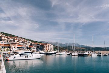 Fototapeta na wymiar Luxurious yachts at the dock of Lustica Bay. Montenegro