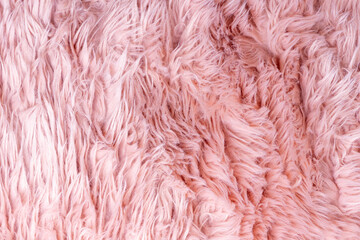 Trendy pink artificial fur texture. Fur pattern top view. Pink fur background. Texture of pink shaggy fur. Wool texture. Flaffy sheepskin close up