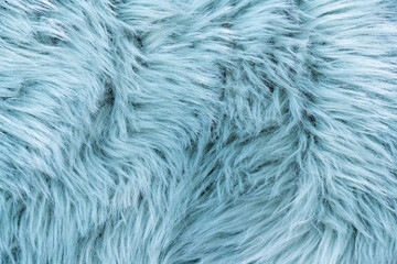 Trendy artificial fur texture. Fur pattern top view. Blue fur background. Texture of blue shaggy fur. Wool texture. Flaffy sheepskin close up