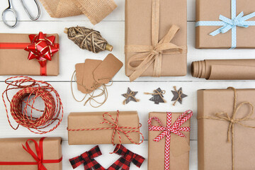 Christmas Flat Lay - Plain brown kraft paper wrapped presents with accessories filling the entire...