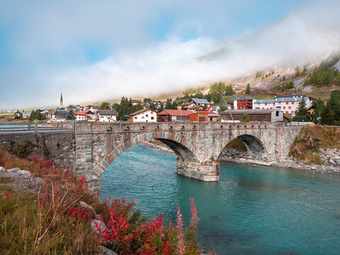 Old bridge over river Inn in Zuoz, municipality in the Maloja Region in the Swiss canton of Graubunden