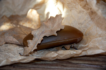 An oak leaf on a bar of soap. Bath accessories for hygiene.