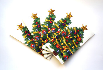 white christmas napkins with an image or green with toys and gifts