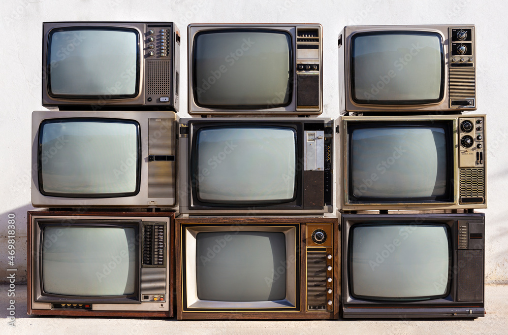 Wall mural pile retro old television (tv) background