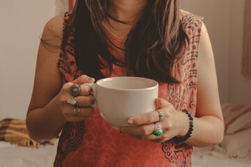 girl holding a big mug of latte