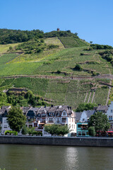 View on Mosel river, hills with vineyards and old town Zell, Germany