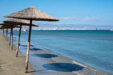 Beach unbrellas and chairs on sunny sandy beach Lady's mile in Akritori, Cyprus