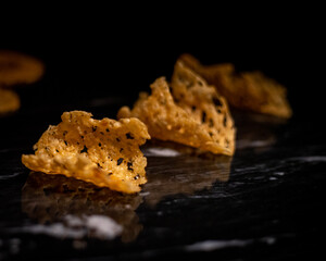 Gruyere Cheese Fricos on Black Marble