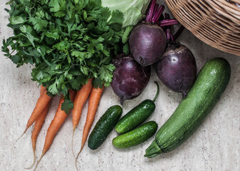 A straw basket and a harvest of vegetables from the market, top view.