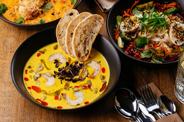 corn soup with shrimp in a black plate