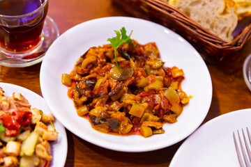 Traditional turkish food Saksuka tarifi with eggplant, tomatoes and olive oil