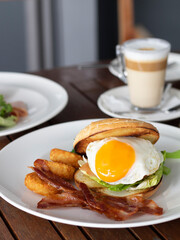 Cosy Sunday brunch with bacon, egg, fries and a cup of latte.