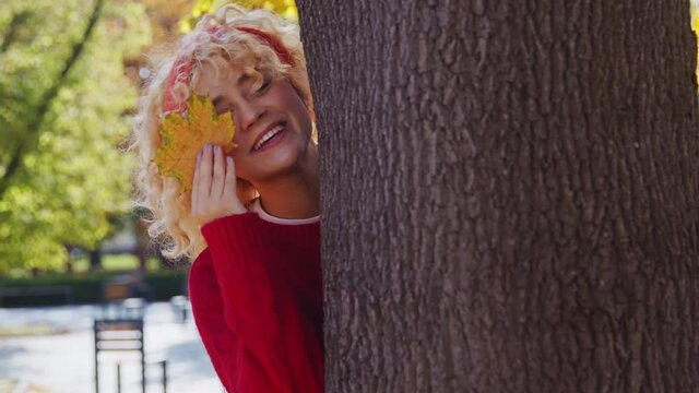 Nitwit polish teen playing with a maple leaf autumn season