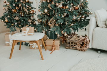 Christmas Decoration 2022. Happy New year 2022. Gold, silver and white Balls on Christmas tree branch. .Christmas toy ball hanging on branch of spruce. New year tree decorated with a garland