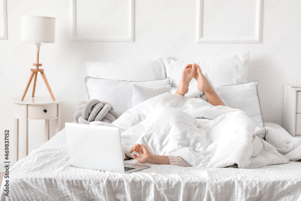 Sticker Morning of young woman with laptop lying in bed