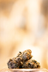 Cannabis in glass with gold background