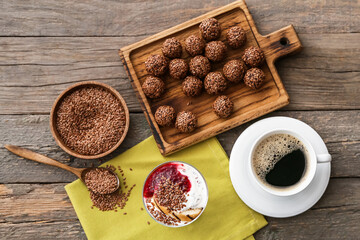Tasty desserts with flax seeds and cup of coffee on wooden background