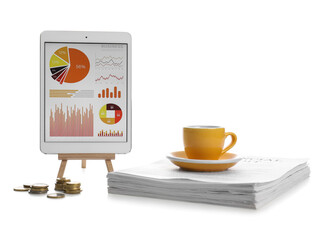 Tablet computer with cup of coffee and stack of documents on white background