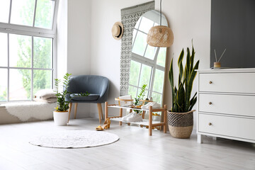 Interior of light hall with big mirror, shoes stand and armchair