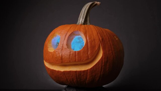 Colorful Eye Glowing Jack O Lanterns Spinning With Black Background For Halloween. - Close up