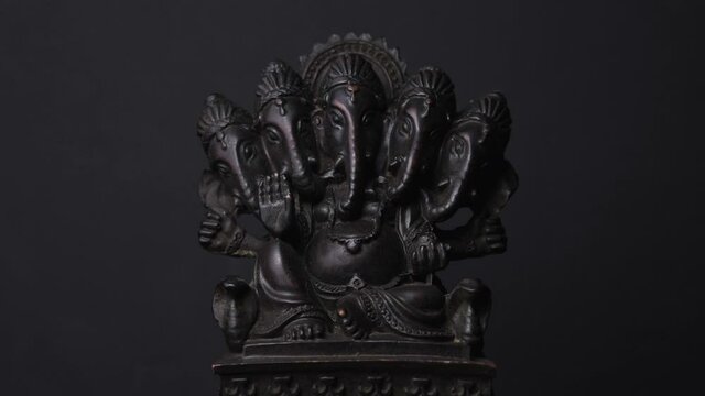 Five Head Ganesha Sculpture Spinning, From Light to Dark Shadow. - Close Up 
