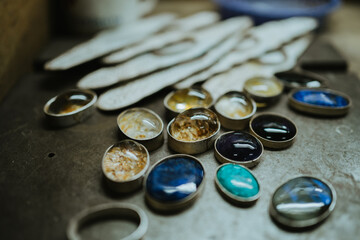 Jeweler at work in jewelry. Desktop for craft jewelry making with professional tools. Close up view of tools. Silver jewelry.