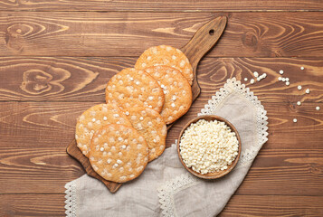 Tasty cookies with white chocolate chips in board on wooden background