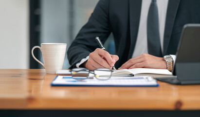 businessman working at office with document on his desk, doing planning analyzing the financial report, business plan investment, finance analysis concept	