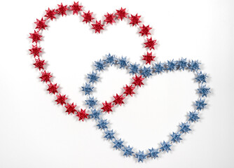 Floding paper stars in red and blueon white background.
