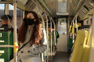 Multi-age caucasian people in face masks protection drive in a bus.