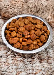 bowl of dried dogfood pellets with copy space