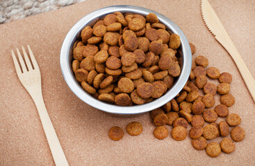 bowl of dried dogfood pellets with copy space