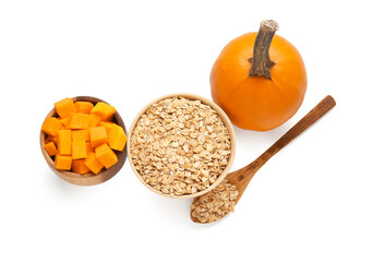 Bowls with oatmeal flakes and pumpkin pieces on white background