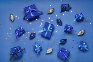 Composition with Christmas gift boxes and balls on blue background
