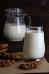 Fresh milk, oatmeal cookies on a wooden background.Christmas drinks. Selective focus.