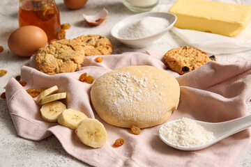 Fresh dough and ingredients for preparing homemade cookies on light background