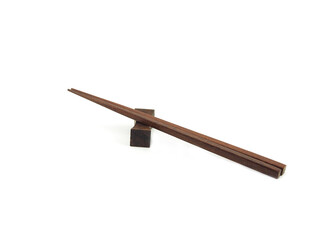 Brown wooden chopsticks on chopstick-rest isolated. Use for home or restaurant, food design. Kitchen accessory. Japanese style.