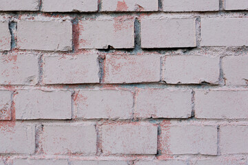 Old painted brick wall. Texture of rough brickwork. Masonry background.
