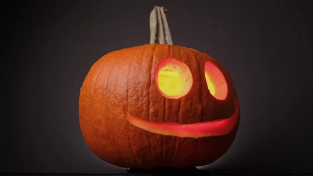 Colorful Flaming Cheerful Pumpkin, Jack O Lanterns, Spinning on Halloween. - Close up 