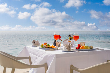 Luxury breakfast table with food for two with beautiful tropical sea view background. Morning...