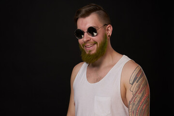 cheerful bearded man in white t-shirt sunglasses posing