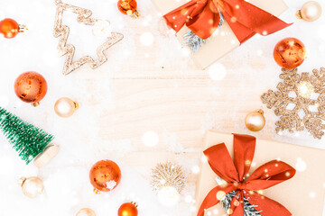 Christmas wood snow. Xmas board with old rustic wall, white frozen snowflake, golden balls and gift box. Winter wooden decoration background. Happy new year copy space.